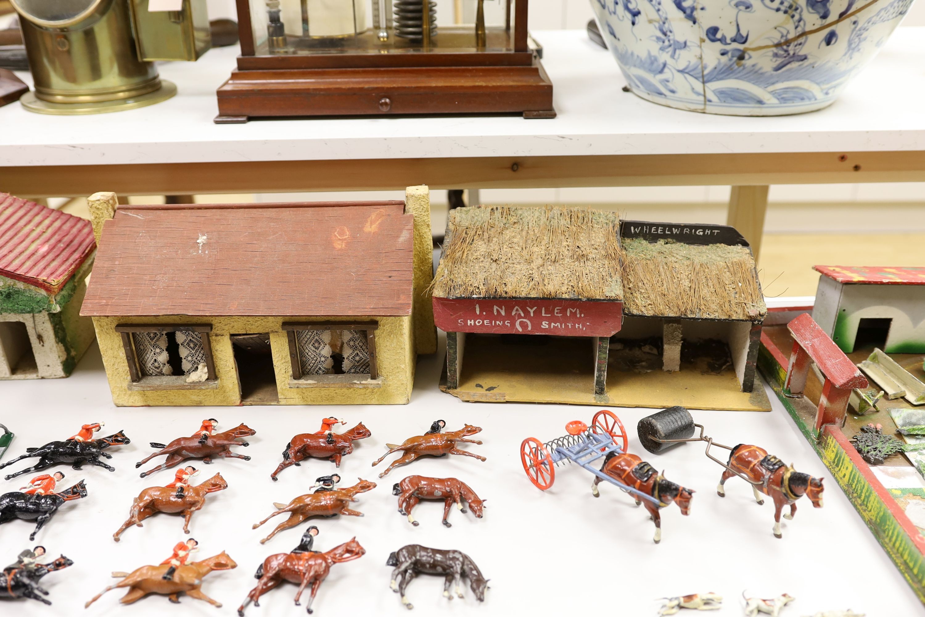 A collection of mainly Britains painted lead figures and animals, including huntsmen and hounds, farm workers, animals and wooden buildings